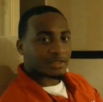 A man with short black hair and a trimmed beard, dressed in a red collared shirt, sits indoors and looks directly at the camera. He exudes the confidence of a skilled service professional—like an electrician or plumber.