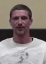 A man with short hair and a trimmed beard, wearing a white shirt, sits against a two-toned background. He stands out among service professionals such as HVAC technicians and plumbers.