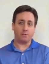 A man with short dark hair and a blue polo shirt, representing service professionals like plumbers or HVAC technicians, stands in front of a plain white background.