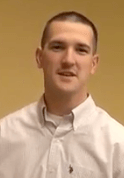 A man with short brown hair and a light-colored button-up shirt stands in front of a plain beige wall, projecting the professionalism typical of Service Professionals.