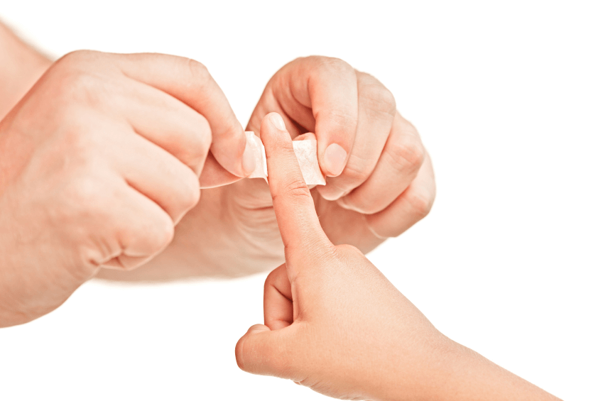 An adult—possibly an electrician—applies a bandage to a child’s finger against a white background.
