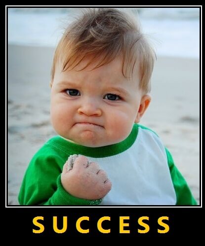 A baby at the beach clenches a fistful of sand, wearing a determined expression—like plumbers tackling tough jobs. "SUCCESS" appears in bold yellow letters beneath the image.