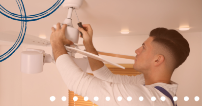 Electrician installing a ceiling fan