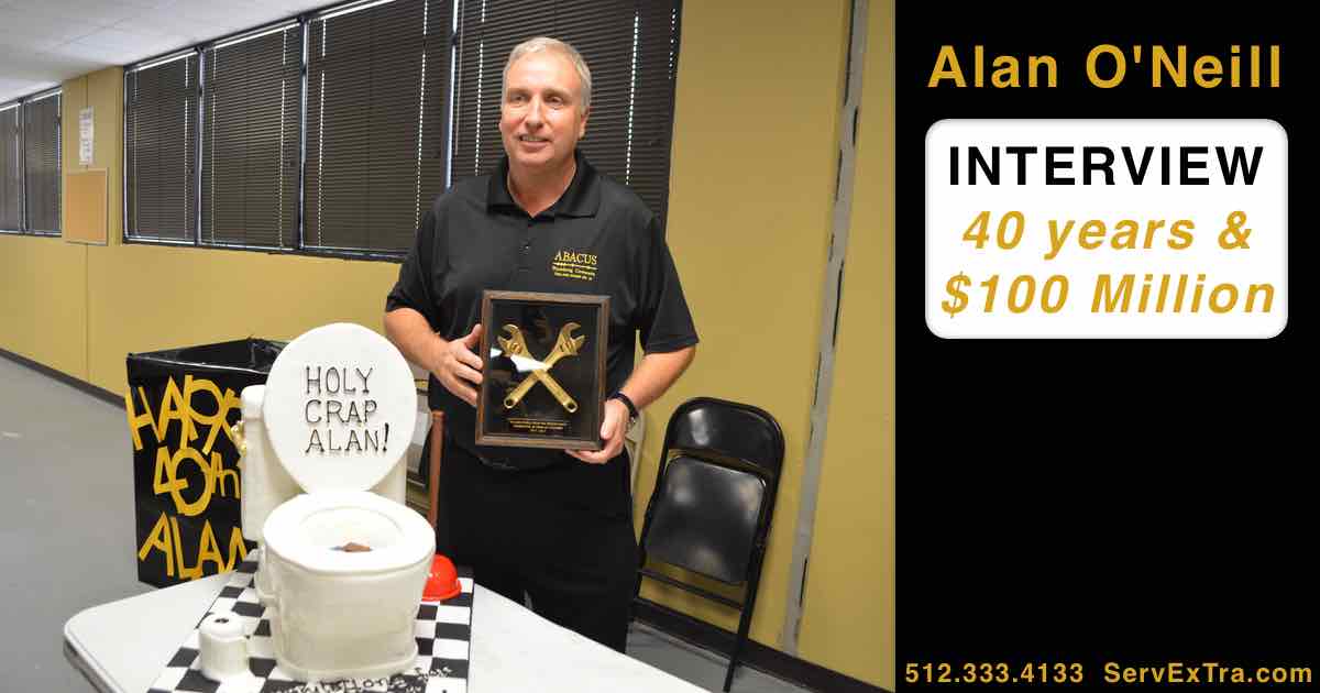 A man—possibly an electrician—stands beside a toilet-shaped cake and holds a plaque. A sign promotes his interview about 40 years and $100 million in business achievements.