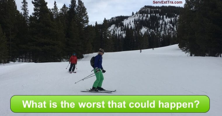 Two people ski down a snowy slope, trees and a mountain rising in the background. The image asks, "What is the worst that could happen?"—a playful reminder that Service Excellence begins with trying something new.
