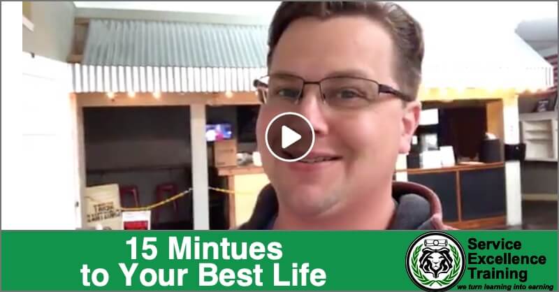 A man wearing glasses smiles at the camera indoors. At the bottom, text says, "15 Minutes to Your Best Life" and "Service Excellence Training for Service Professionals.