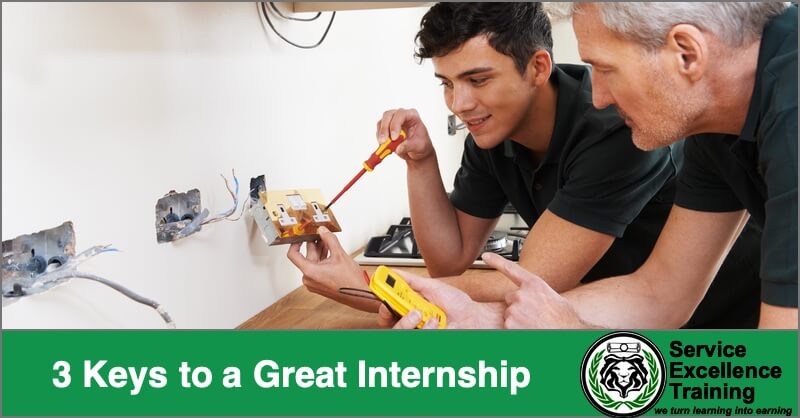 Two men in work uniforms, likely electricians, install electrical outlets. One holds a screwdriver; the other uses a voltage tester. A banner displays "3 Keys to a Great Internship" alongside the Service Excellence Training logo.