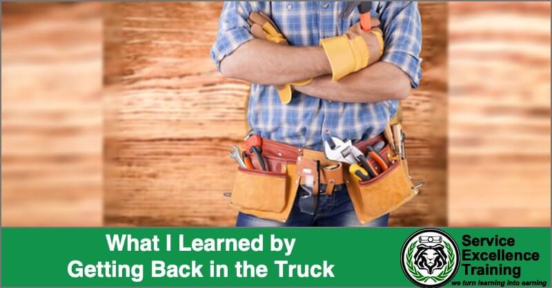 An electrician wearing a tool belt and gloves stands with arms crossed. The overlaid text reads, “What I Learned by Getting Back in the Truck.” The Service Excellence Training logo appears in the corner. This provides valuable insight for any electrician looking to grow.