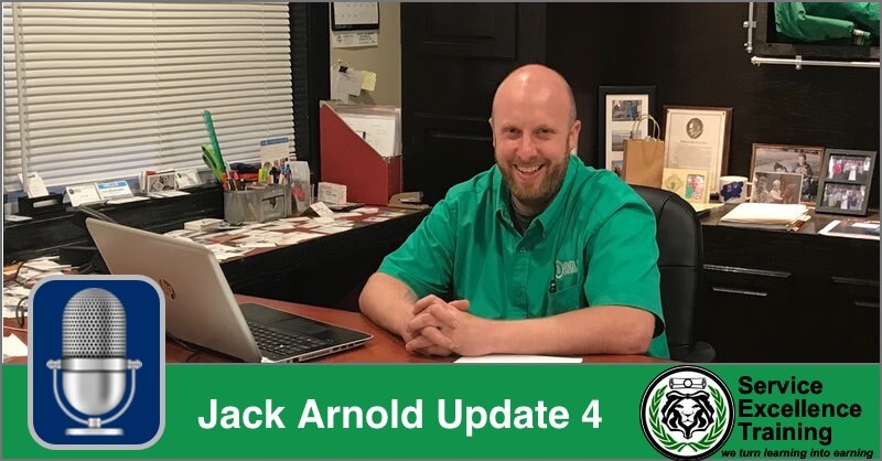 Jack Arnold sits at his office desk, smiling at the camera. The text says, "Update 4" and "Service Excellence Training for Plumbers.