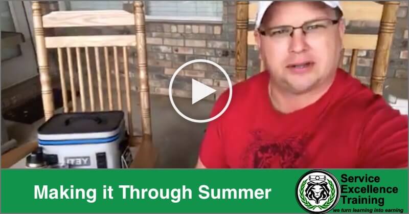 A man in a red shirt and white cap sits on a porch beside a cooler. The text "Making it Through Summer" appears with the Service Excellence Training logo—ideal inspiration for electricians and other hardworking Service Professionals.