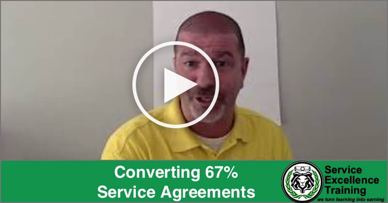 A man in a yellow shirt explains coaching insights in a video titled "Converting 67% Service Agreements," with the Service Excellence Training logo displayed in the corner.