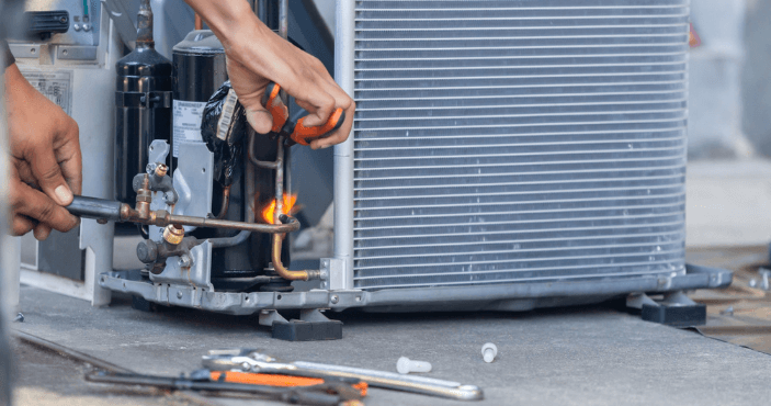 technician performing an AC repair