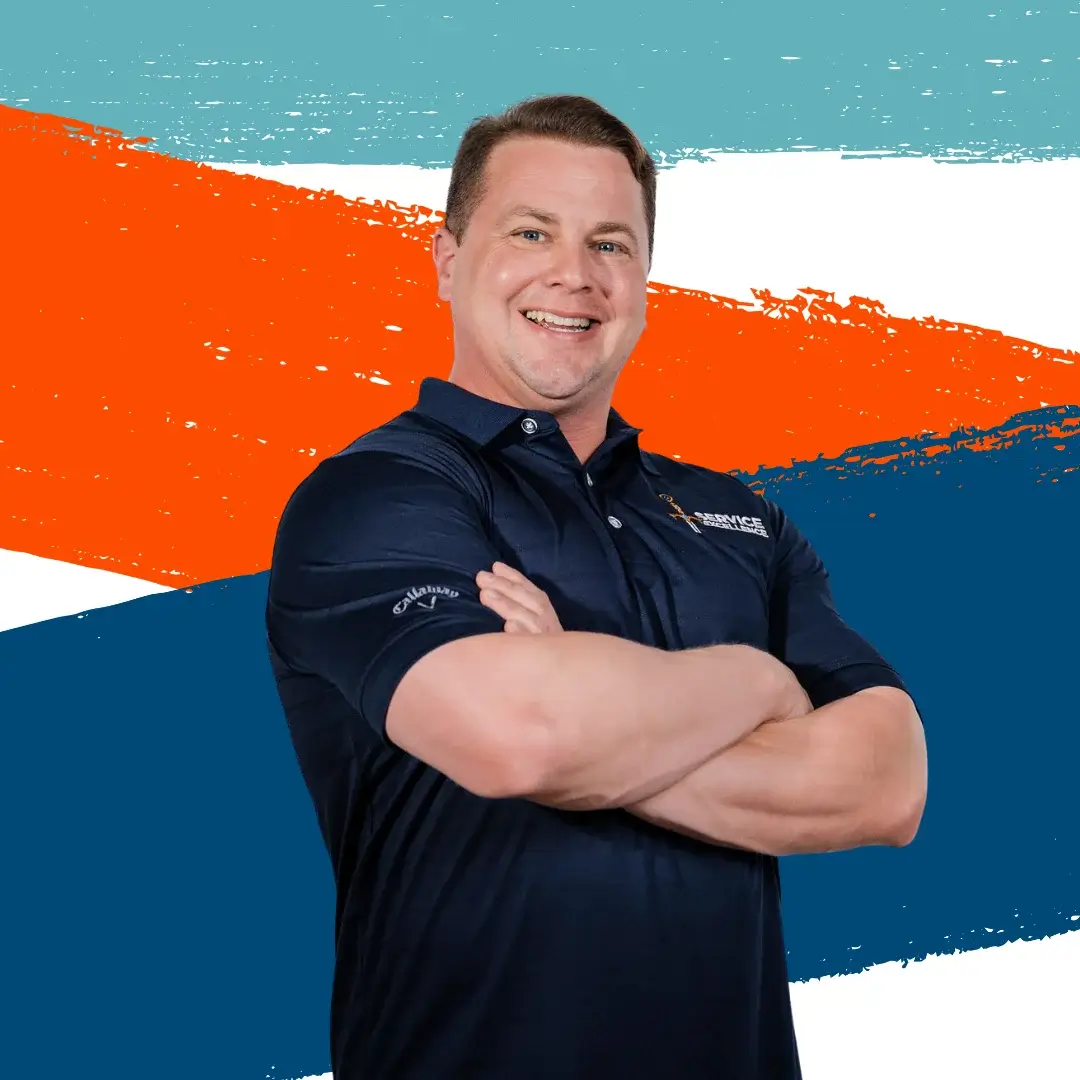A man in a navy polo shirt stands with his arms crossed and smiles in front of bold blue, orange, and white diagonal brush strokes—perfect for home service business owners or anyone looking for top-tier home services.